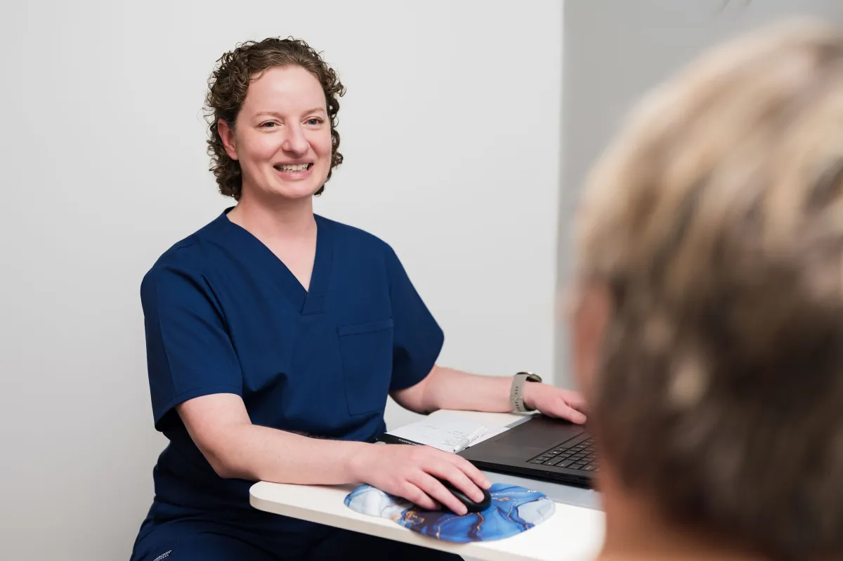 Dr. Shannon Foster smiling across her desk during a visit